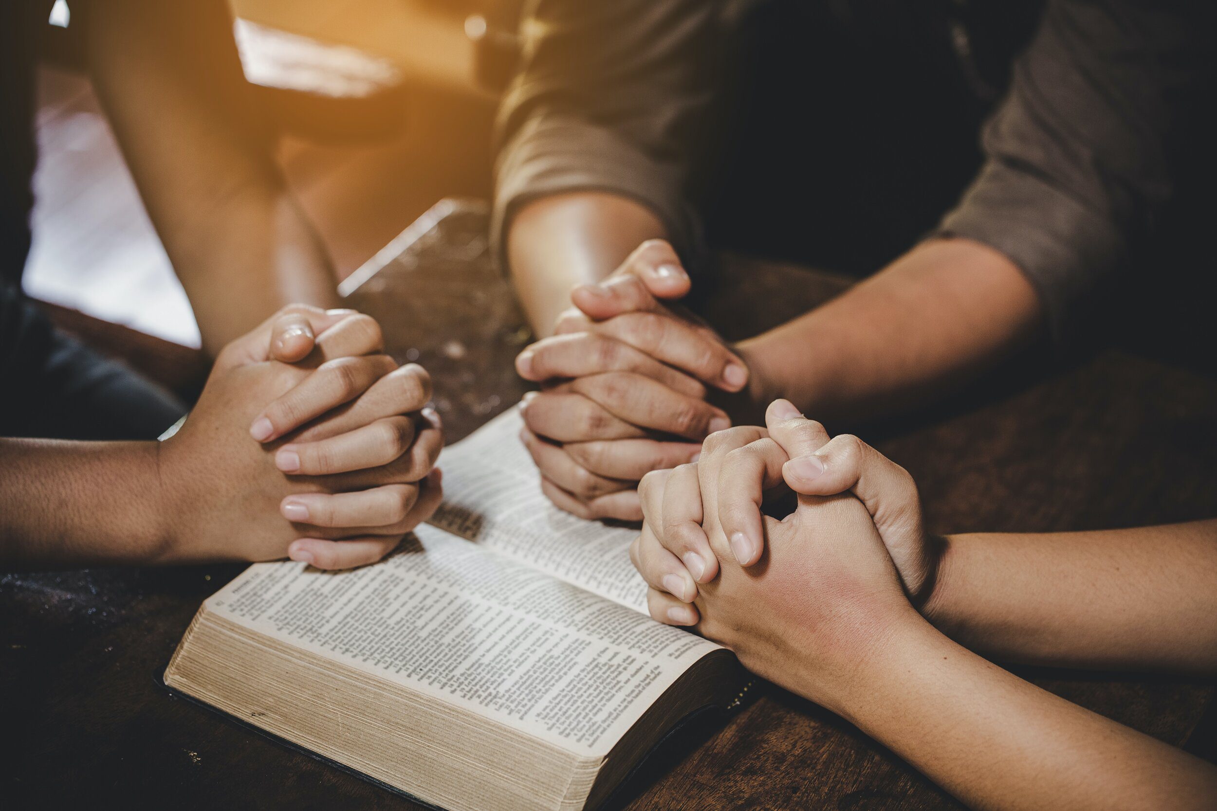 Group of different women praying together, Christians and Bible study concept.